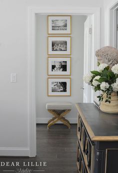 a vase with white flowers sitting on top of a dresser