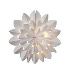 a large white flower shaped light hanging from the ceiling