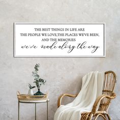 a chair and table in front of a wall with a quote on it that says, the best things in life are the people we love their places we've