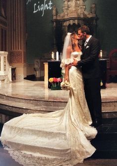 a bride and groom standing in front of a church alter with the words, wedding night light written on it