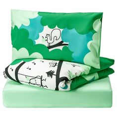 a bed with green sheets and pillow cases on top of each other in front of a white background