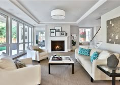 a living room with couches, chairs and a fire place in the fireplace area