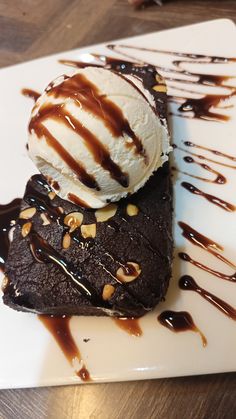 a piece of chocolate cake with ice cream on top