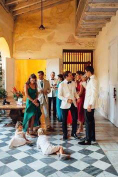 a group of people that are standing in front of a door and on the ground