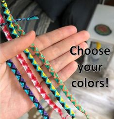 a person holding three different colored braided bracelets with the words choose your colors