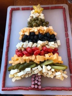 a christmas tree made out of cheese and olives