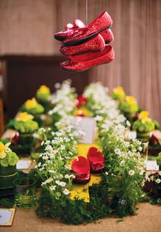 a collage of pictures with red shoes and green flowers on the table, yellow flowers in vases