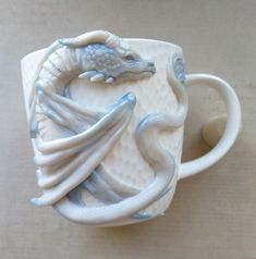 a ceramic cup with a dragon on it