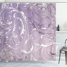 a purple shower curtain with white swirls on it in a bathroom next to a bathtub