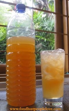 a bottle and glass filled with liquid sitting next to each other