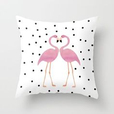 two pink flamingos standing next to each other on black and white polka dot background