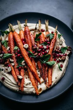 carrots and other vegetables are on top of a pita