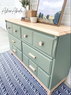 an old dresser is painted green and has a painting on it with the words, after all that