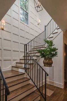 a plant is sitting on the stairs in this house