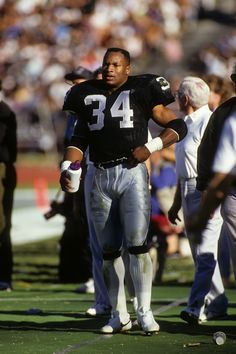 a football player is walking on the field