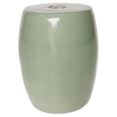 a light green ceramic stool on a white background