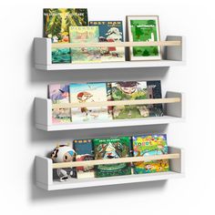 two white shelves with books on them and pictures hanging from the top one shelf is filled with children's books