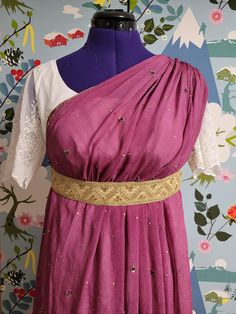 This overdress is a half length, one shoulder overdress with a softly draped looked inspired by the romanesque gowns favored during the Regency era.  The fabric is a soft silk with embroidery and beads. The color is between a pink mauve and purple.  The dress gets it's draped shape by a hidden drawstring. This also allows for different sizes to wear this dress. The included ribbon in gold with beads can be extended to above 95cm and will close with clothing pins (included) or a brooch (not inclu Fitted Silk Regency Style Dress, Regency Dress Purple, Fitted Regency Style Embroidered Dress, Regency Sleeveless Spencer, Jane Austen Dress, Regency Round Gown, Embroidery And Beads, Pink Mauve, Regency Dress