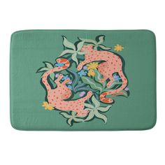 a bath mat with an image of two cats in the middle of leaves and flowers