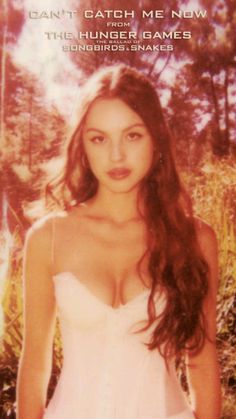 a young woman in a white dress posing for a magazine advertisment with trees in the background