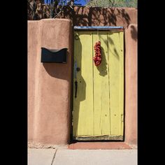 Yellow door Santa Fe New Mexico Chile Ristra, Outdoor Artwork, Yellow Door, Yellow Doors, Santa Fe Style, Garden Doors, Rustic Charm, Santa Fe, New Mexico