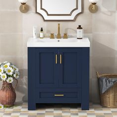 a bathroom vanity with blue cabinet and white sink