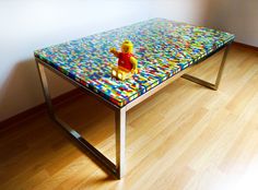 a glass table with a toy winnie the pooh on it in front of a window