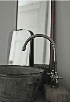 a bathroom sink sitting under a mirror next to a faucet and soap dispenser