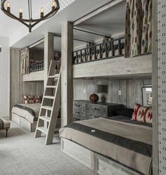 a room with bunk beds, couches and a ladder to the top of it