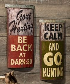 two signs are hanging on the side of a wooden wall, one says keep hunting and the other reads be back at dark go hunting