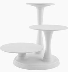 three white pedestals are stacked on each other in order to form the same table