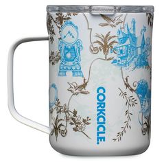 a white and blue coffee mug with an ornate design on the front, inside it