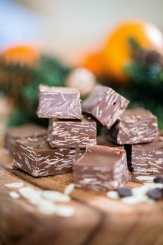 pieces of chocolate sitting on top of a wooden table