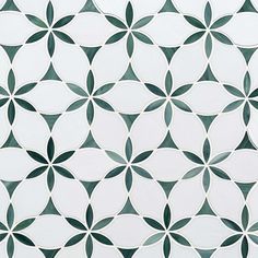 a white and green tiled wall with circular designs