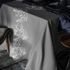 the table is covered with an embroidered cloth