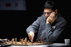 a man sitting at a table playing chess