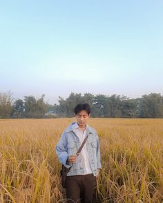 A boy standing in the field carrying rice grain in hand , wearing a jeans denim  jacket mix with formal outfit and converse chuck 70s Formal Pant Shirt, Self Portrait Photoshoot, Denim Jacket Outfit Ideas, Photography Self Portrait, Jacket Outfit Ideas, Chuck 70s, Fall Outfits Ideas, Formal Pant, Denim Jeans Jacket