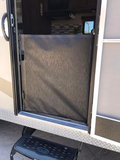 the inside of a trailer with its door open and screen on it's side