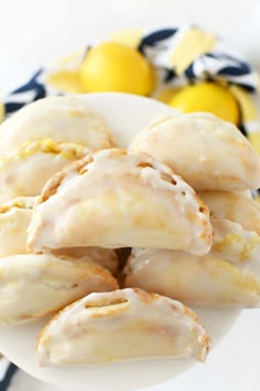 lemon meringue rolls on a plate with lemons in the backgroung