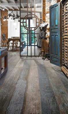 a room with wooden floors and blue doors