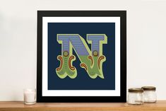 the letter n is made up of two green boots on top of a wooden shelf