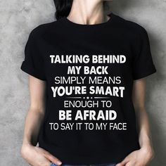 a woman wearing a black t - shirt that says talking behind my back simply means you're smart enough to be afraid to say to say it to my face