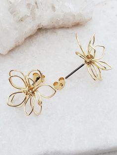 These earrings feature beautiful large 3D flowers handcrafted out of 16kt gold plated wire. Stainless steel posts. Just over 1/2" long. Matching necklace found here Dangle version found here Handmade in San Jose, California! Flower Shape Earrings With Ear Wire For Gift, Spring Flower Earrings With Ear Wire, Party Flower-shaped Earrings With Ear Wire, Yellow Gold Flower-shaped Jewelry With Ear Wire, Rose Gold Flower-shaped Earrings With Ear Wire, Flowers Earrings, Wire Flowers, San Jose California, Hair Accessories Gift