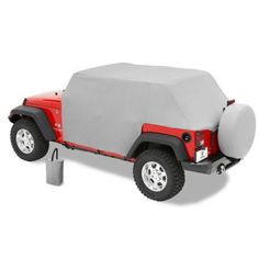 a red jeep with a gray cover on it