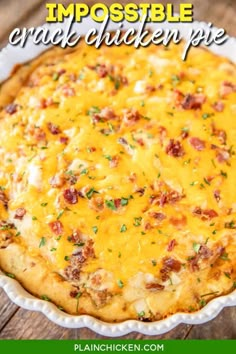 a cheesy casserole in a white dish on top of a wooden table