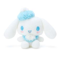 a white stuffed animal with blue eyes and a light blue pom - pom on it's head