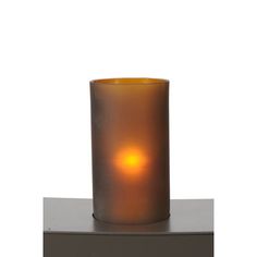 a lit candle sitting on top of a table