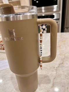 a coffee cup with a straw in it on a counter top next to a microwave