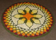 a colorful flower design on the floor in a circular pattern with orange, yellow and green colors