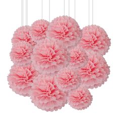 pink tissue pom poms hanging from strings